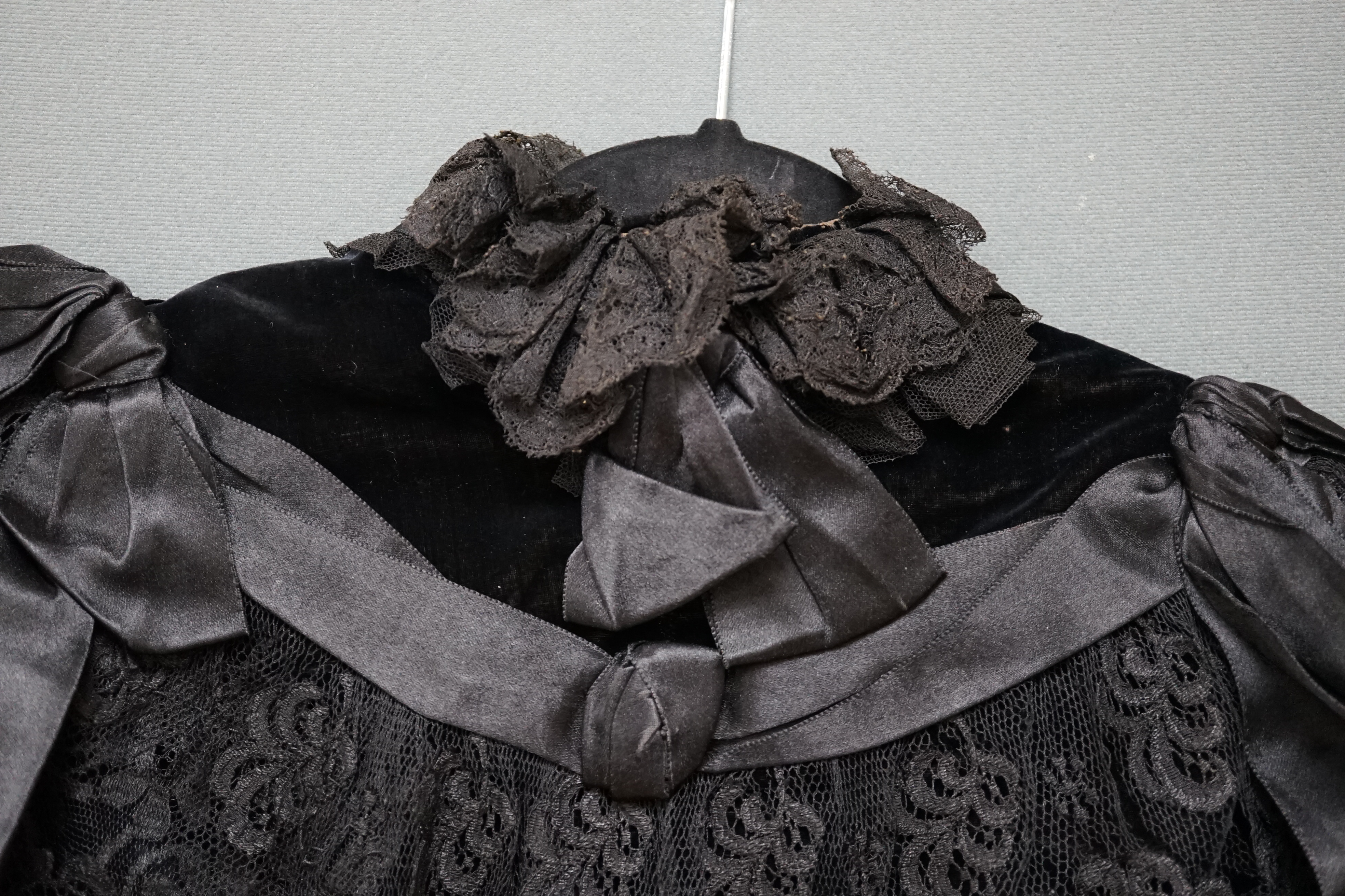 An Edwardian black velvet and black lace evening cape together with a purple chiffon and cream lined blouse labelled John Barker and Co, blouse specialists, Kensington, cape back, neck to bottom edge 72cm. Condition - th